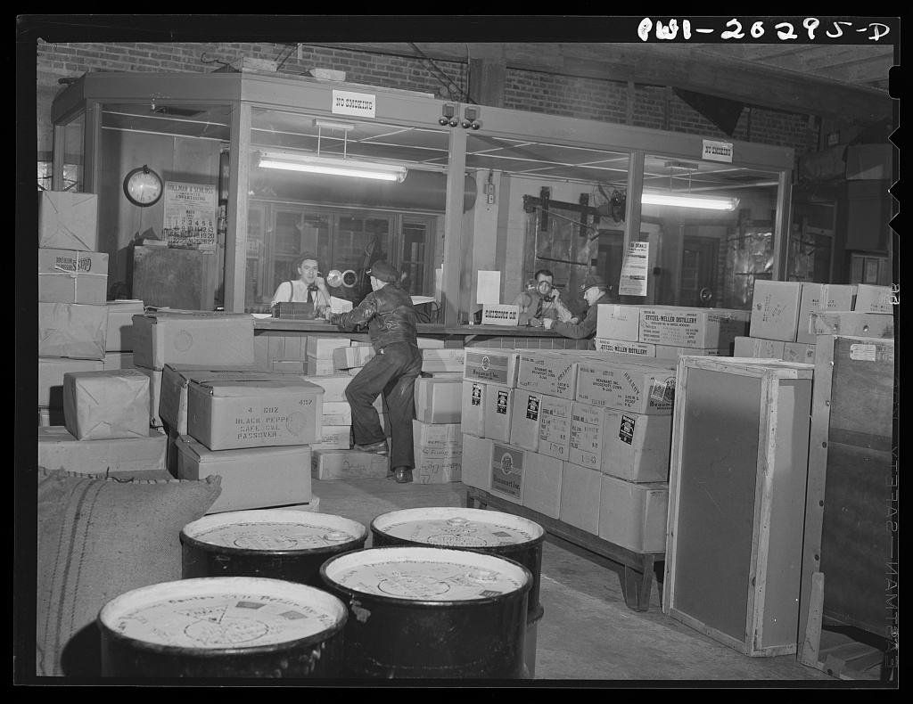Public domain photograph of truck drivers gathered in a dispatcher office.